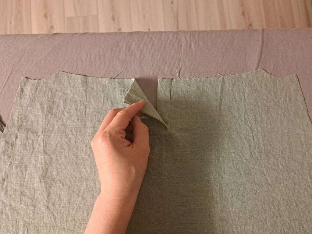 finished placket on skirt being held open by a hand