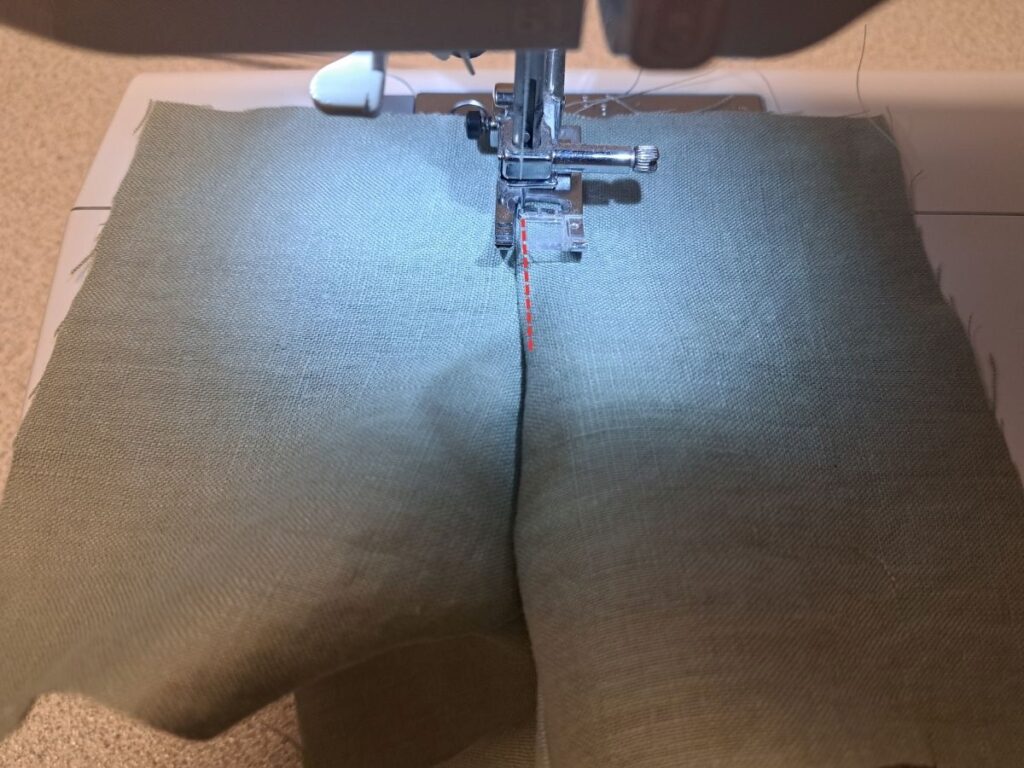 picture of bodice at sewing machine with stitching line indicated in red