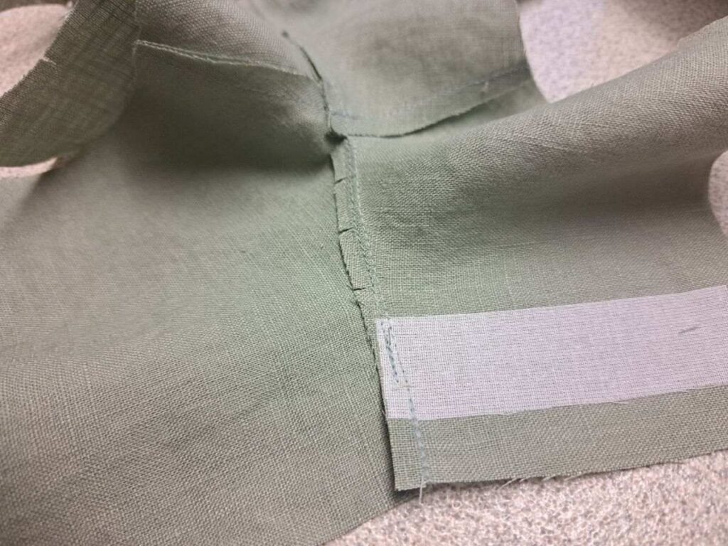 picture of wrong side of bodice so that you can see seam allowance that is trimmed, clipped, and understitched