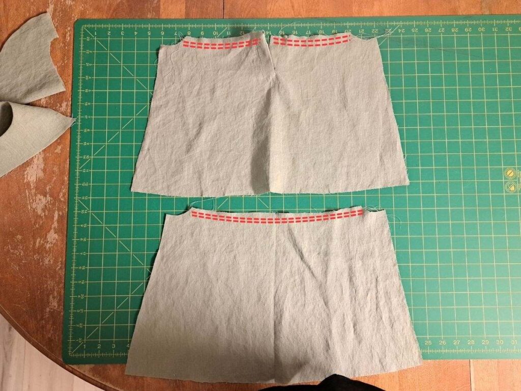 two skirt pieces with gathering stitches indicated in red