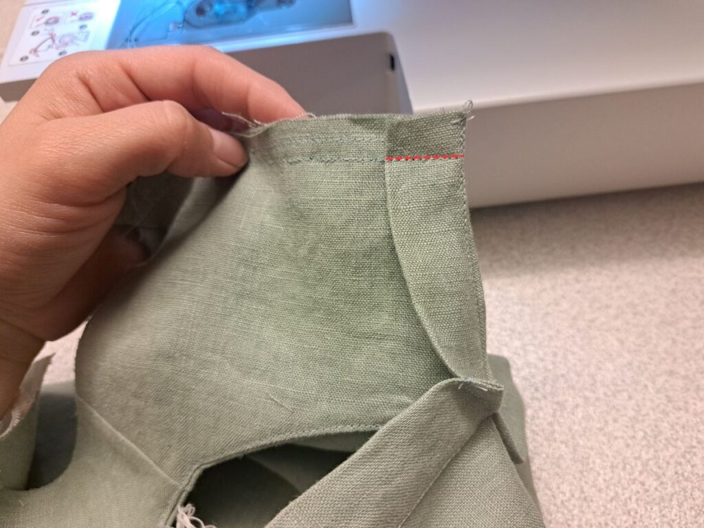 placket folded over bodice with stitching line indicated in red