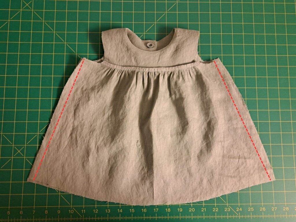 dress laying inside out with stitching lines on skirt part indicated in red