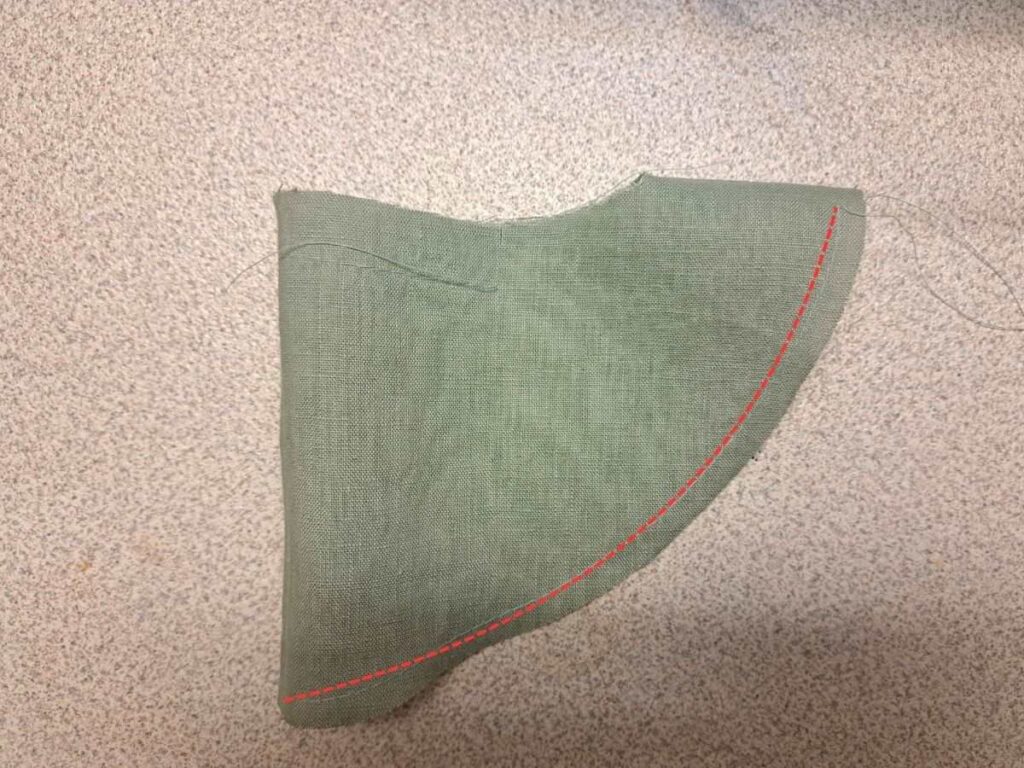 sleeve with ease stitching around hem indicated in red