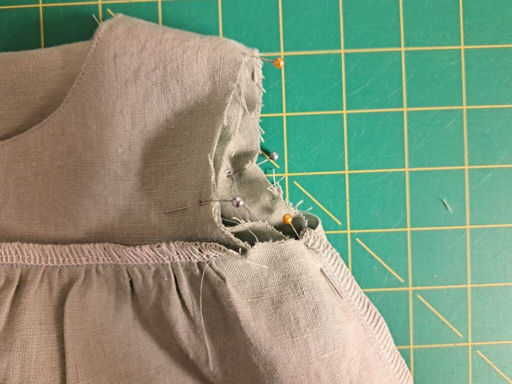 sleeve pinned inside dress with raw edges aligned