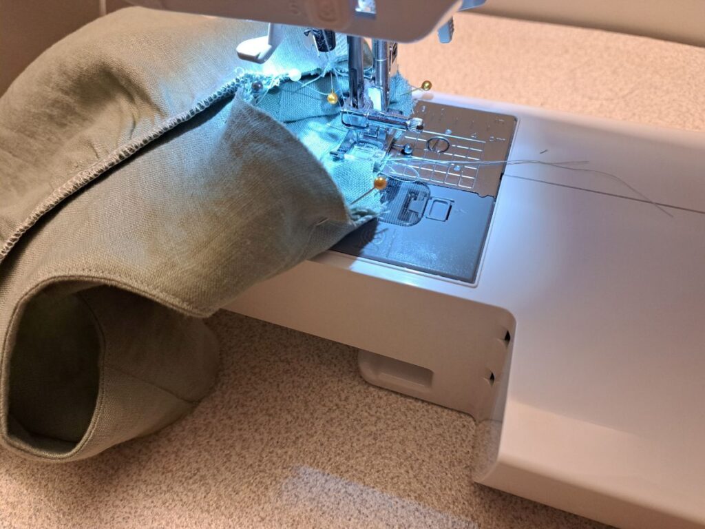 arm opening and sleeve being sewn together at sewing machine