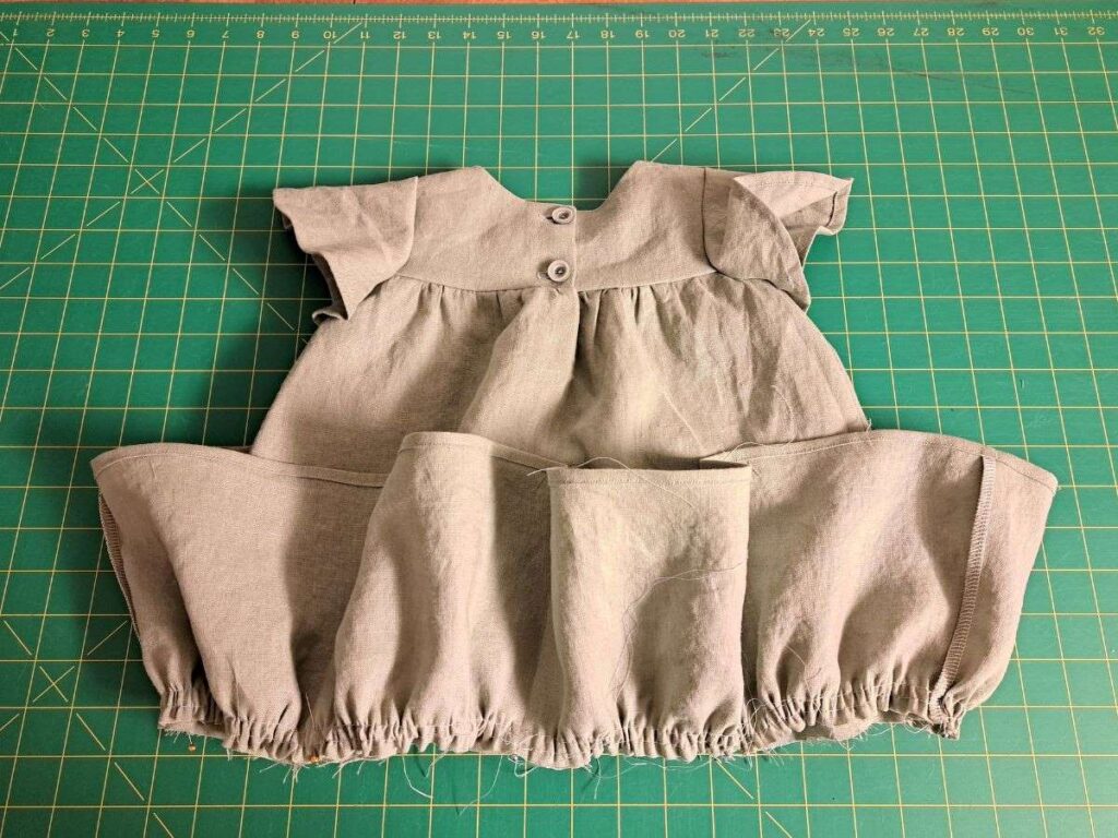 gathered ruffle pinned onto dress